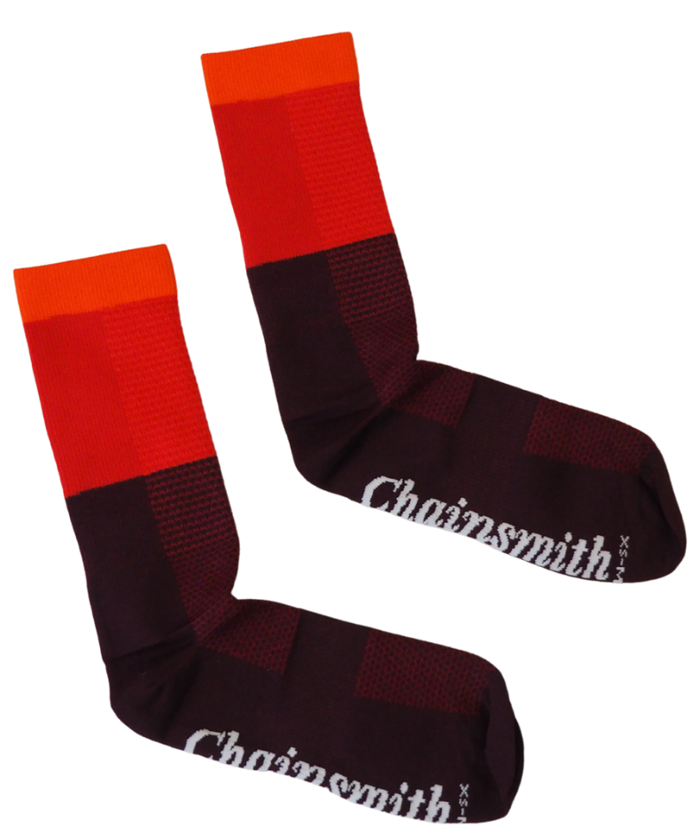 Red tri-colour Chainsmith cycling socks on white studio background