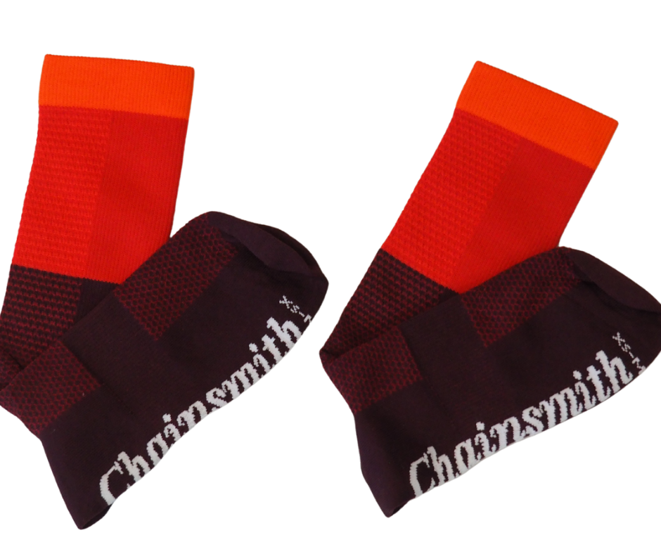 Flat lay of red tri-colour socks with branding visible on cuff