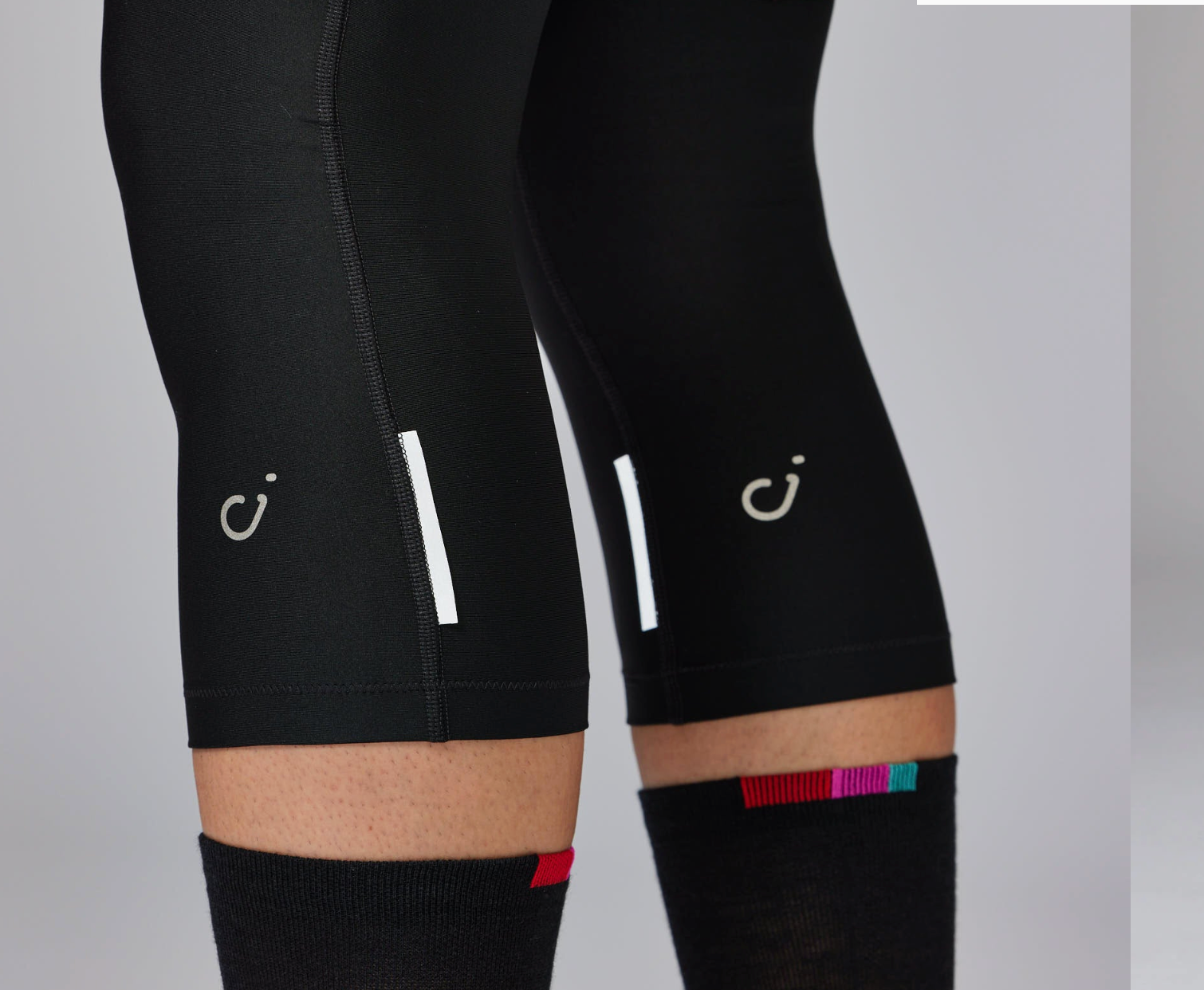 Side profile of Velocio ONE Knee Warmers showing anatomical cycling fit