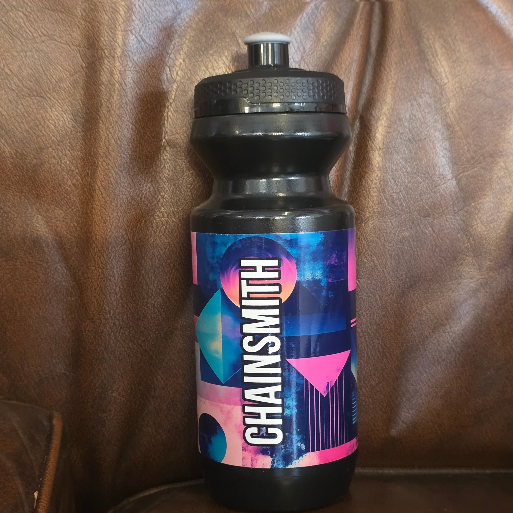 Retro black cycling water bottle detail with vibrant colour graphics